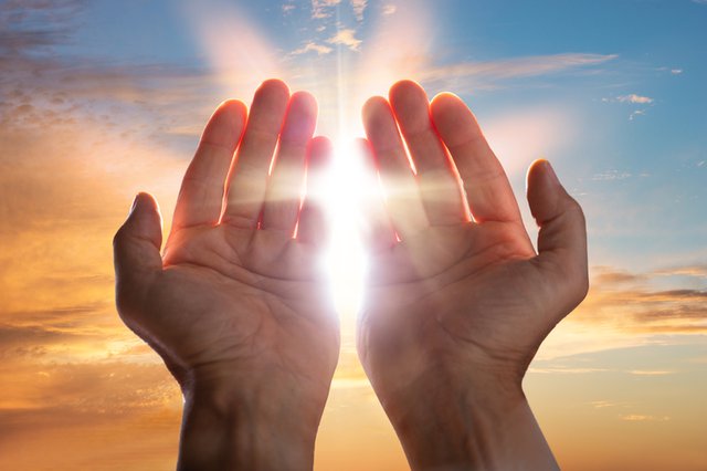Sunlight praying hands